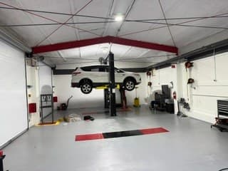 A customer's vehicle on a lift at Coopers DIY Garage
