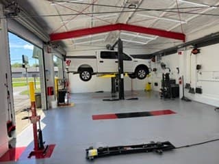 A customer's vehicle on a lift at Coopers DIY Garage